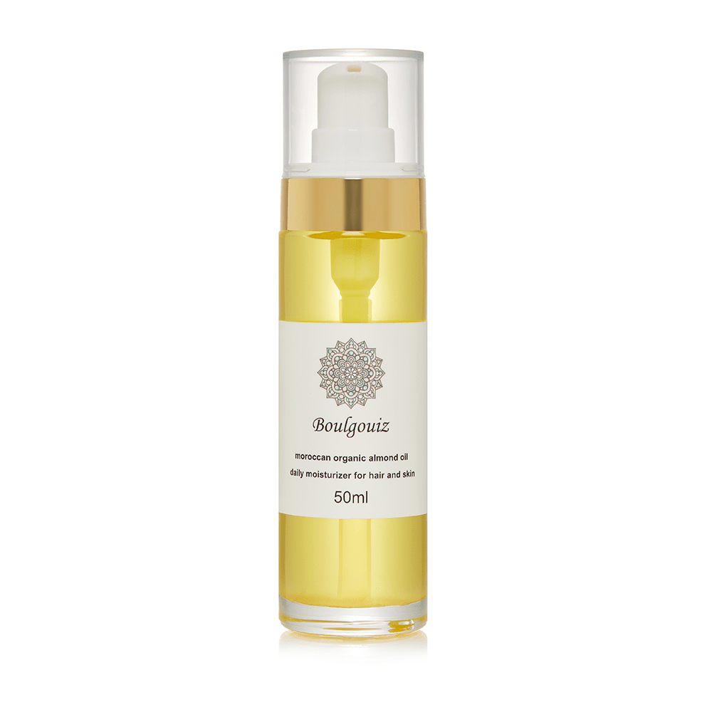 Clear bottle of Boulgouiz Moroccan Organic Almond Oil daily moisturizer for skin and hair on a white background