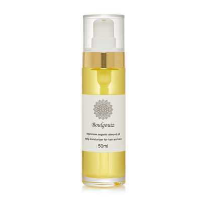 Clear bottle of Boulgouiz Moroccan Organic Almond Oil daily moisturizer for skin and hair on a white background