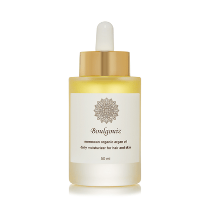Golden bottle of Boulgouiz Moroccan Organic Argan Oil, a daily moisturizer for skin and hair, on a white background